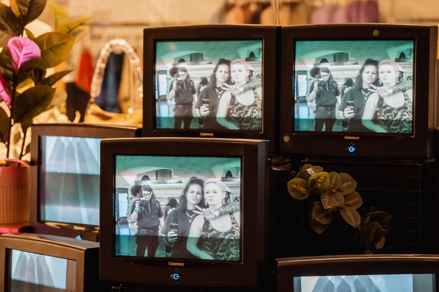 Close-up of retro CRT televisions displaying a live monochrome video feed