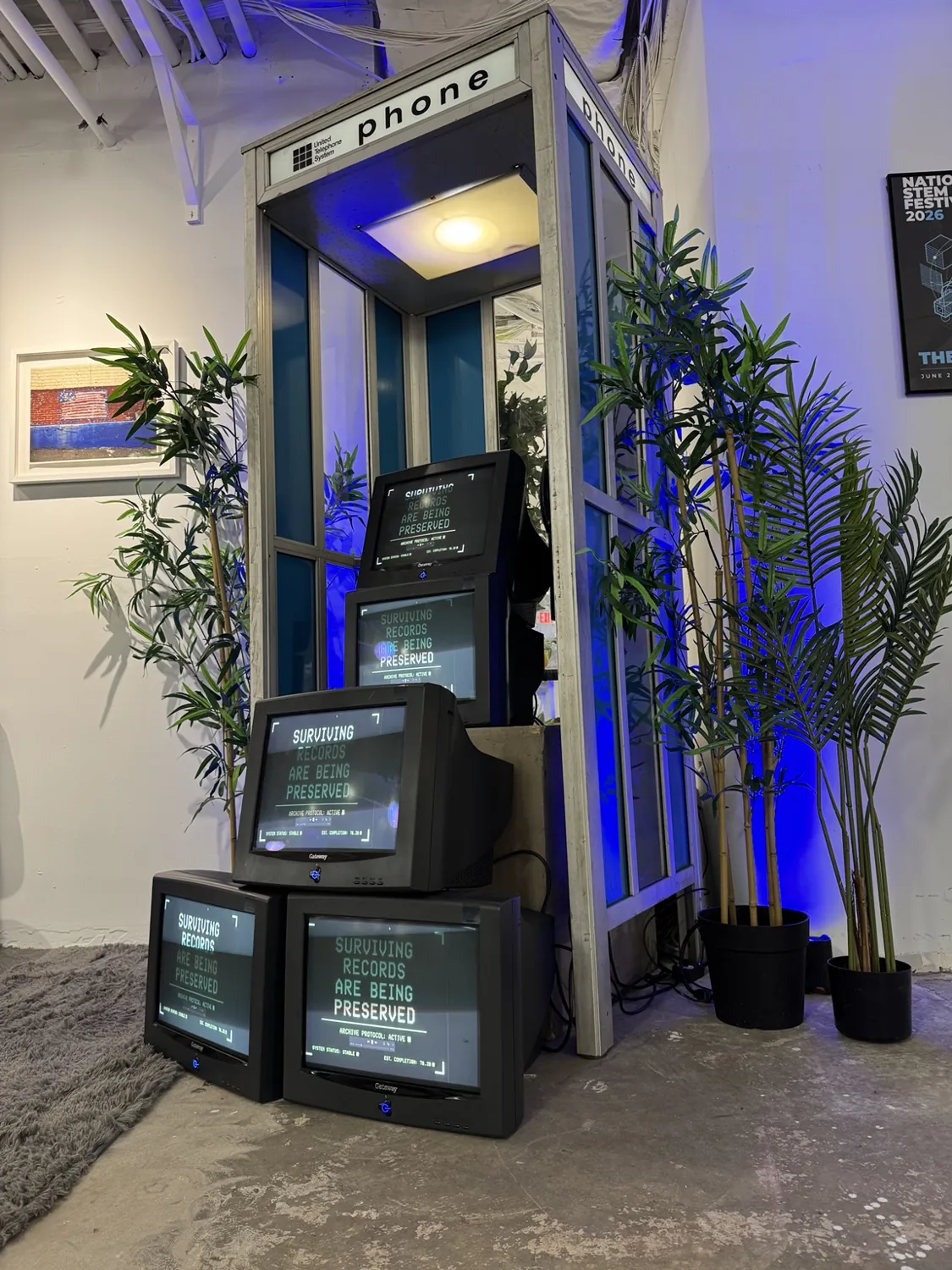 Vintage phone booth containing sculpturally stacked CRT monitors